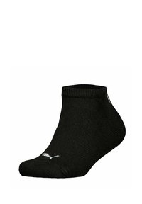 Calcetín negro hasta el tobillo hecho de material canalé con textura suave, con un logo blanco de Puma en la punta y un diseño de corte bajo.