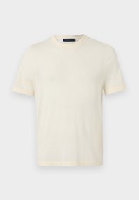 Κοντομάνικο t-shirt σε κρεμ απόχρωση με στρογγυλή λαιμόκοψη, απλό σχέδιο, εμφανίζεται σε επίπεδο ανοιχτό γκρι φόντο.