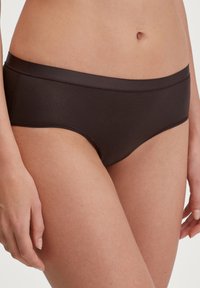 Dark brown seamless hipster underwear with a smooth texture and wide waistband, featuring a minimalist design and no visible hardware.