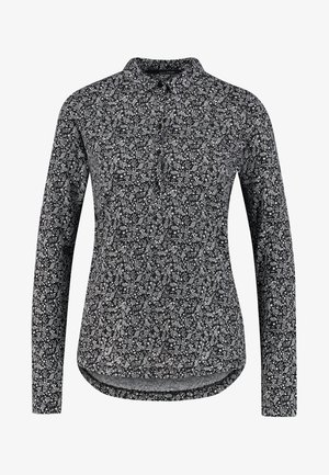 Zwarte lange mouwen shirt met een witte bloemenpatroon, met knopenkraag, rechte zoom en een ronde achterkant. Zachte stof met een gladde textuur.