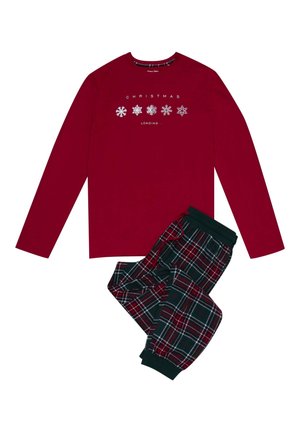 Czerwona bluzka z długim rękawem z napisem "ŁADOWANIE ŚWIĄT..." oraz grafiką płatków śniegu, w połączeniu z zielonymi i czerwonymi spodniami w kratę z zakładanym dołem.