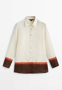 Long-sleeve shirt in cream fabric with a button closure; features orange and brown dip-dyed hem accents, smooth texture, and classic collar.