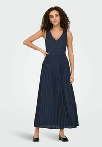 Navy pleated maxi dress with a V-neckline and sleeveless design. Made of lightweight fabric, featuring a fitted bodice and flowy skirt.