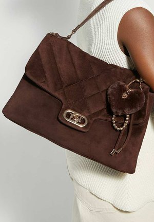 Brown suede handbag with quilted design, silver hardware, and a fluffy heart-shaped charm attached. Features a single shoulder strap.
