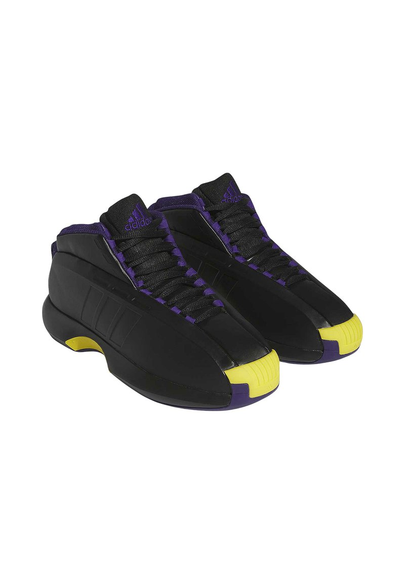 Zwarte sport schoenen met paarse accenten, geprofileerde panelen en een onderscheidende gele neuskap. Beschikt over een laag uitgesneden ontwerp en een gevoerde zool.