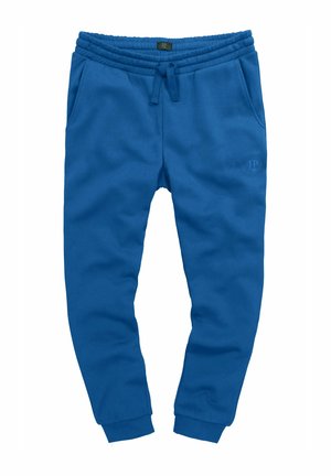 Pantalones de chándal azules fabricados en un tejido suave, con una cintura elástica, cordones, bolsillos laterales y puños acanalados. Detalle sutil del logo.