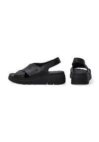 Schwarze Leder-Sandalen mit einem Slingback-Design, ausgestattet mit einer dicken Sohle und einem Kreuzriemen über den Zehen. Strukturiertes Finish und dezente Nähte.
