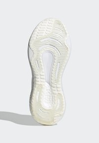 Witte sportschoenzool van textuur rubber, met een golvend patroon en groeven voor grip, met een gladde, gevoerde hielzone.