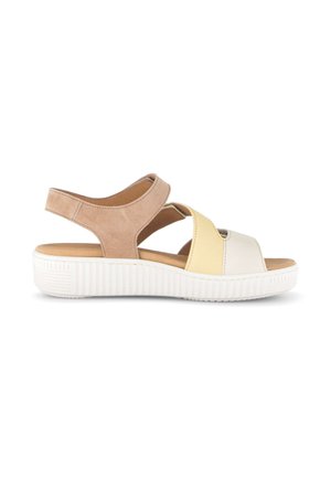 Beige, yellow, and white open-toe sandal with adjustable back strap and thick white ribbed sole, side view on white background.