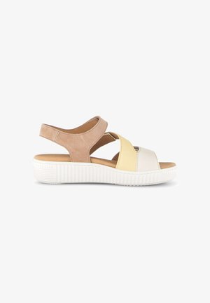 Beige, yellow, and white open-toe sandal with adjustable back strap and thick white ribbed sole, side view on white background.