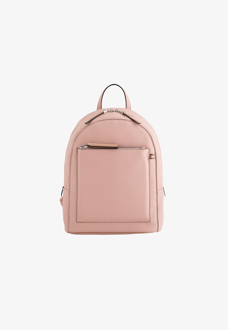 Light pink leather backpack with rounded shape, front zip pocket, and minimalist design. Features top handle and two side pockets.