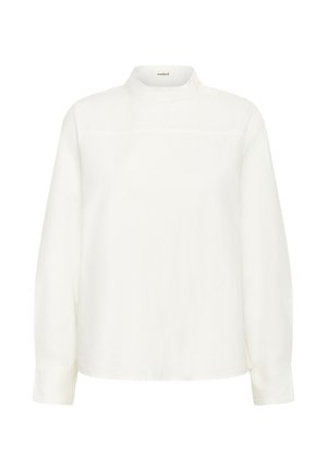 Balta ilga rankovė blouse su aukštu kaklu, lygia tekstūra ir subtiliais siuvinėjimais ant krūtinės. Mygtukų akcentai ant pečių.