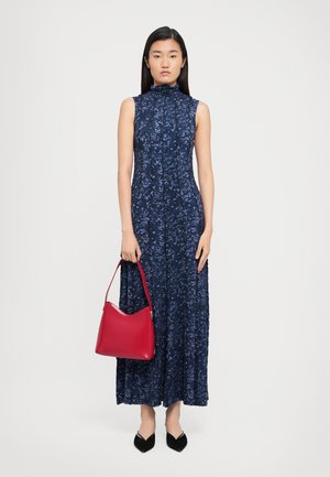 Navy floral maxi dress with a high neck and sleeveless design, paired with a red leather handbag and black pointed-toe shoes.