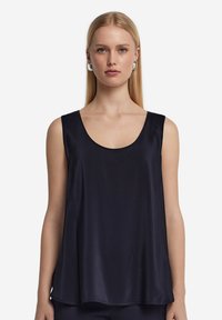 Mörkblå ärmlös topp i mjukt, lätt material med rundad halsringning och avslappnad passform, med ett svängt nederkant.