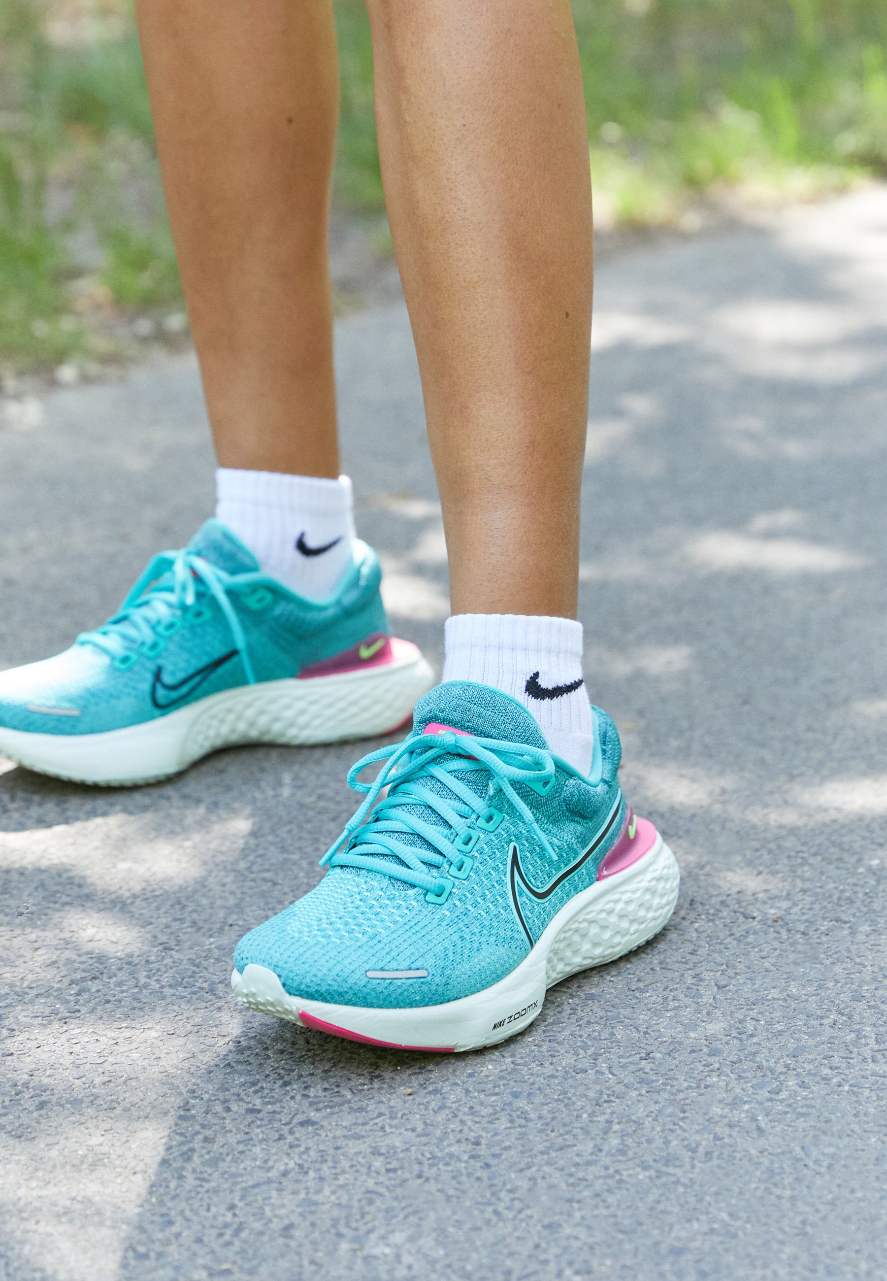 teal and black tennis shoes