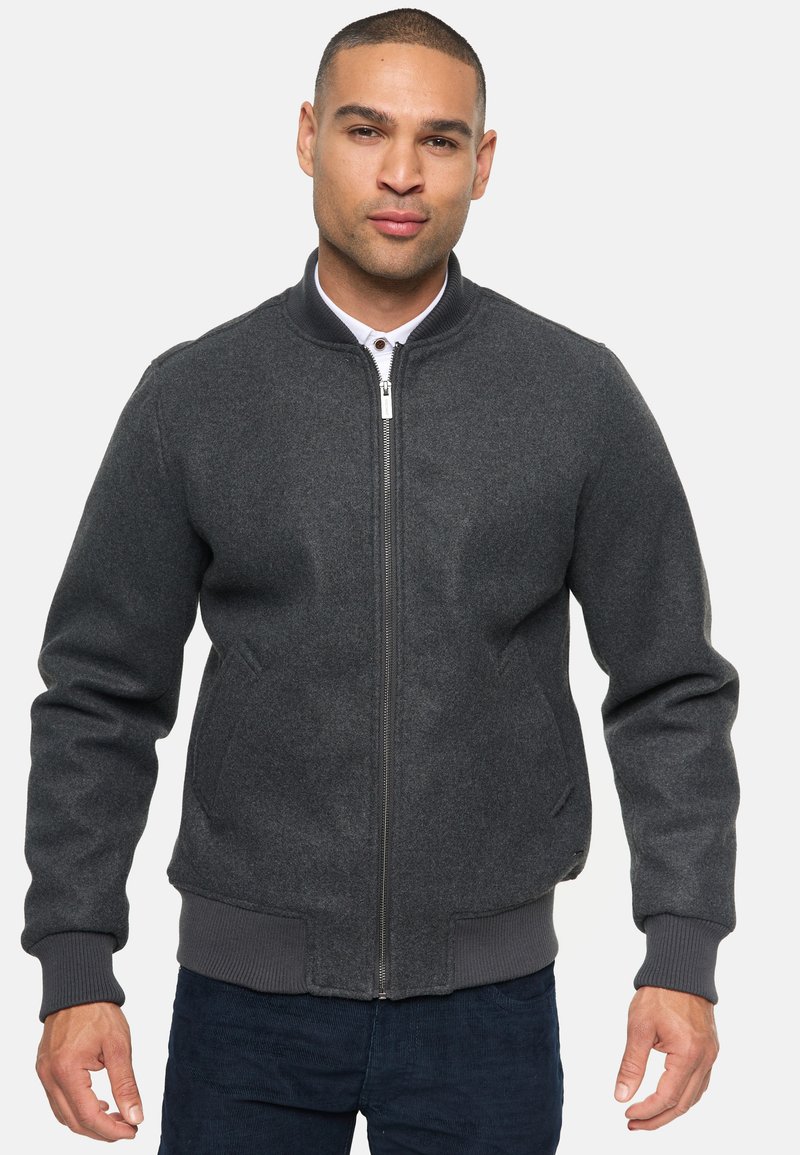 Gray, zip-up bomber jacket with a ribbed collar and cuffs; smooth texture, side pockets, and minimalistic design without patterns.