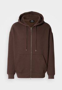 Brown zip-up hoodie made of soft fabric, featuring a spacious front pocket, drawstrings on the hood, and ribbed cuffs at the sleeves.