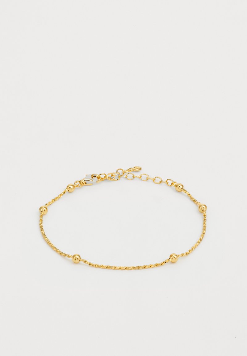 Auksinės spalvos apyrankė su sukta grandinėlės dizainu, tolygiai išdėstytais sferiniais akcentais ir vėžliuko tipo užsegimu.