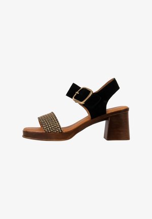 Black suede and woven fabric sandal, featuring a block heel, adjustable buckle, and textured insole for comfort.