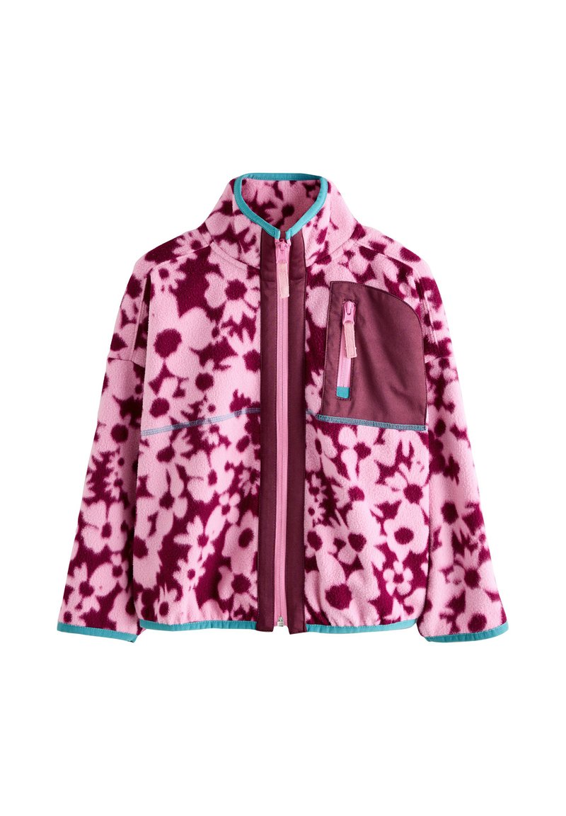 Rózsaszín polárdzseki sötétrózsaszín virágmintával. Magas gallérral, cipzáras záródással, kontrasztos türkiz szegéllyel és mellzsebbel rendelkezik.