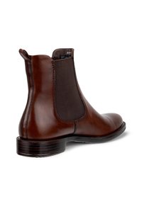 Brown leather Chelsea boot with elastic side panel, pull tab at heel, low stacked heel, and rounded toe shown from side angle.