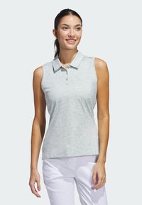 Polo shirt in light gray with a subtle pattern, sleeveless design, buttoned collar, and a fitted shape, paired with white pants.