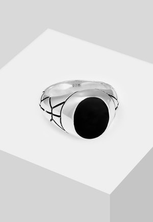 Silver ring featuring a black oval stone, with a smooth band and a woven pattern accenting the sides. Marked 925 for sterling silver.