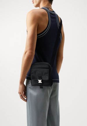 KOME UNISEX - Across body bag - noir