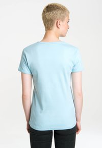 Light blue cotton short-sleeve t-shirt with a rounded neckline, smooth texture, and neatly stitched edges, viewed from the back.