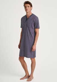 Dark purple nightgown with a geometric pattern in red and blue, short sleeves, Henley collar, and front pocket. Soft cotton texture.