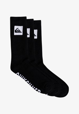 Black cotton crew socks with ribbed texture, featuring white logo on the ankle and brand name printed along the foot. Set of three pairs.