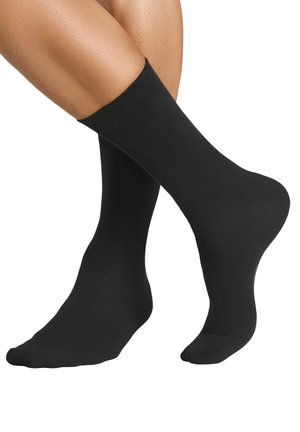 Black ankle socks made of smooth, stretchy material. Features a ribbed top and a seamless toe for comfort.