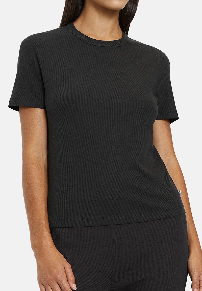 Black ribbed t-shirt with short sleeves, round neckline, and a fitted silhouette. Fabric appears smooth with subtle texture.