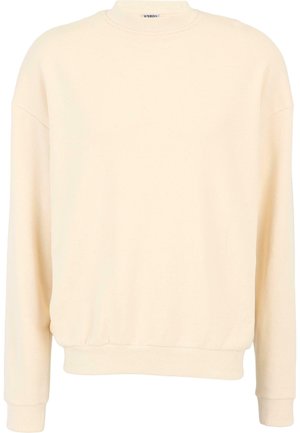 Kremfarget hettegenser laget av myk stoff, har rund halslinning, senkede skuldre og ribbet mansjett og kant. Enkel design.