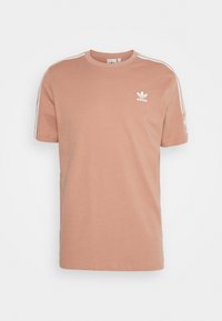 Kortärmad, ljusrosa Adidas-t-shirt med vit logotyp, rund hals och kontrasterande vita sidostråk. Tillverkad av mjukt bomullsmaterial.