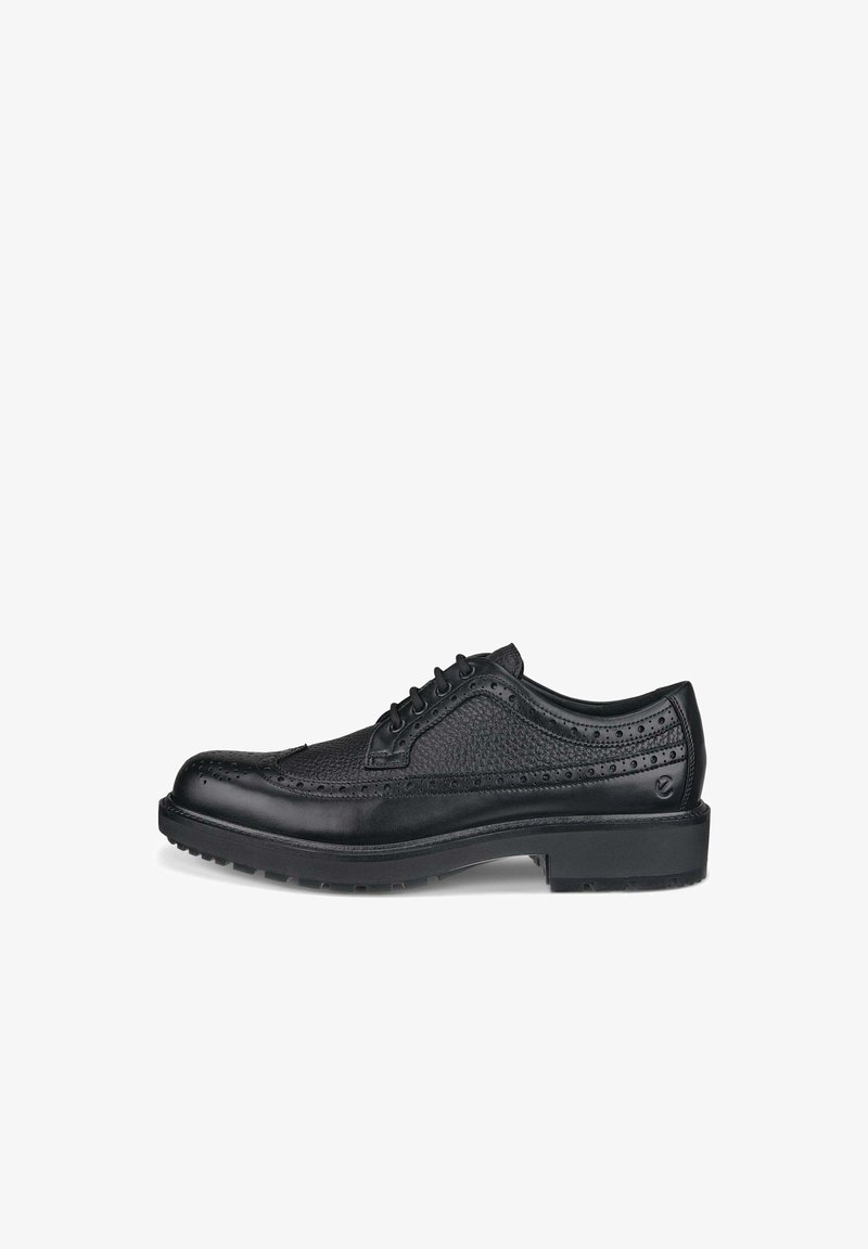 Μαύρο δερμάτινο παπούτσι με πνευματικά σχέδια, στρογγυλή μύτη, σύστημα κορδονιών και υφή στην επιφάνεια. Διαθέτει επίπεδη καουτσούκ σόλα με ελαφριά φτέρνα.