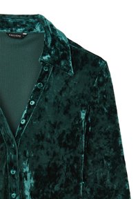 Dark green velvet shirt with a collar, button front, and a soft texture. Features subtle variations in color and shading throughout.