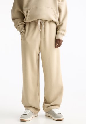 BAGGY - Tracksuit bottoms - beige