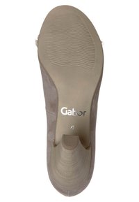 Semelle de chaussure grise en caoutchouc avec des rainures texturées, présentant un bout arrondi et un petit talon. Marque visible « Gabor » près de la voûte plantaire.