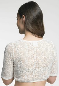 Weißes, kurzes Spitzenoberteil mit kurzen Ärmeln, das über komplizierte Blumenmuster und eine glatte, strukturierte Oberfläche verfügt. Die Rückansicht zeigt Details des Ausschnitts.