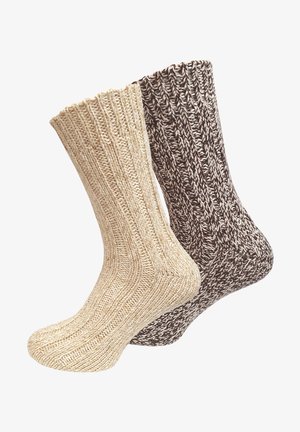 Two pairs of knitted socks: one in cream with a textured rib design and the other in dark brown with a contrasting pattern.