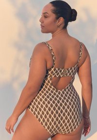 Costume intero con motivo geometrico beige e marrone, spalline regolabili, schiena con ritaglio e chiusura a clip sicura.