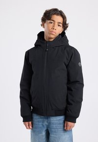 Black hooded jacket with zip closure, ribbed cuffs, and hem. Features a textured fabric and a logo patch on the left sleeve.