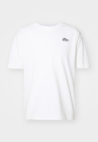 White short-sleeve crew neck t-shirt with a small embroidered sneaker design on the upper left chest.