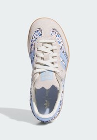 Hellgraue Wildledersneaker mit blauen Akzenten; florales Muster an den Seiten; weiße Schnürsenkel; abgerundete Form; Gummisohle; Logo auf der Zunge.