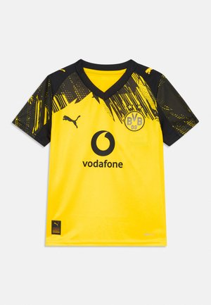 Κίτρινη και μαύρη φανέλα ποδοσφαίρου της Borussia Dortmund με λογότυπα Vodafone και Puma, και γραφικό σχέδιο στους ώμους και τα μανίκια.
