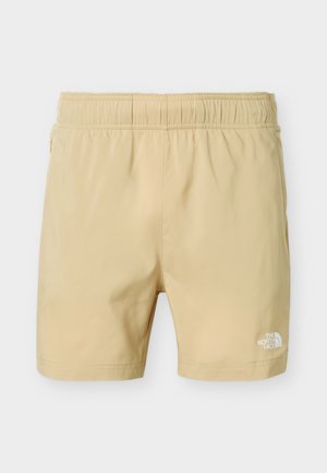 Beige korte broek met elastische taille, zijzakken en het The North Face-logo op het onderste deel van het rechterbeen.