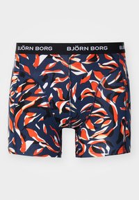 Men's boxer briefs in navy fabric with a colorful wave pattern in red, white, and black. Features a solid black waistband with brand logo.