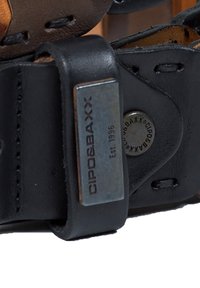 Black leather strap featuring a metal tag embossed with "CIPO & BAXX" and "Est. 1996"; includes stitching and a round metal accent.
