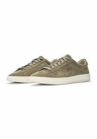 Suede sneakers in a muted olive color with flat laces, a rounded toe, and a white rubber sole. Minimalist design with side stitching details.
